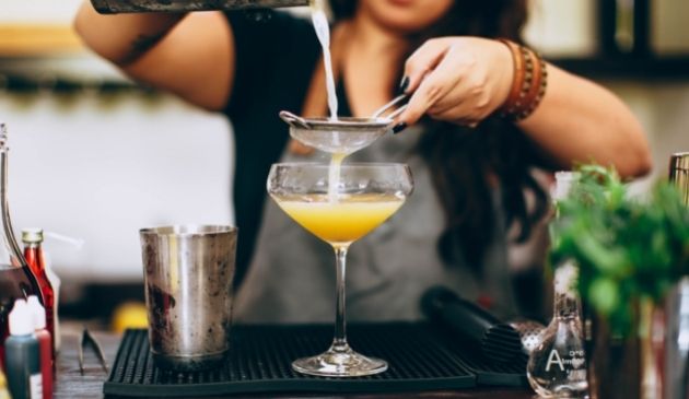Woman making a cocktail