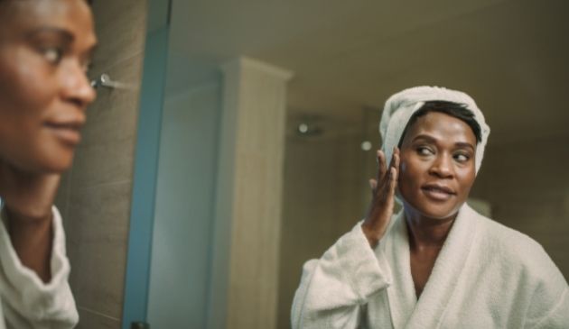woman applying face lotion