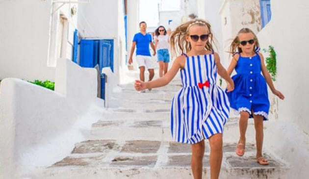 Two girls walking in through a Greek town