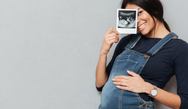 Woman holding pregnancy scan