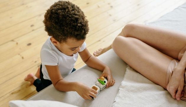 child playing with toy car