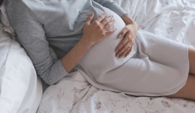 Woman holding pregnant bump