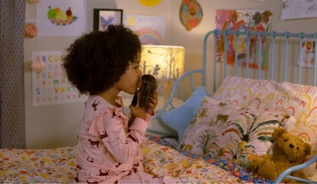 child at bedtime with Barbie doll