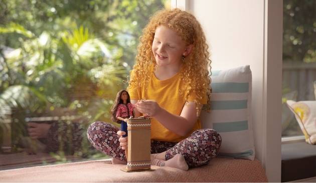 child playing with Barbie doll