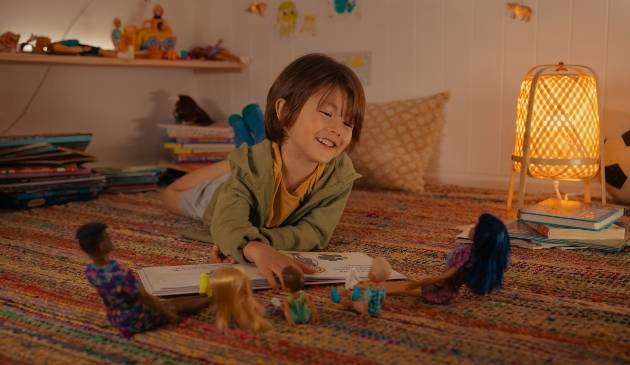 child playing with Barbie dolls