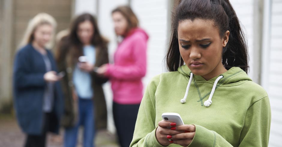 sad girl looks at phone