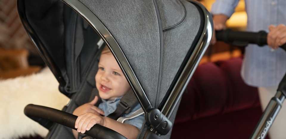 Laughing boy sitting in icandy peach buggy