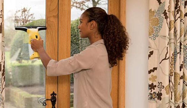 Woman using a Karcher window vac