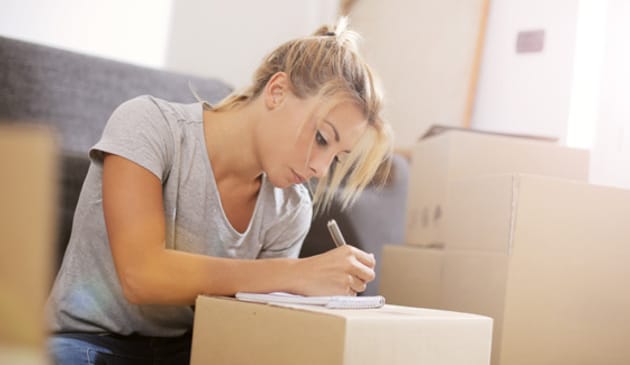 Woman writing on box
