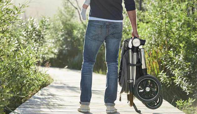 Man carrying Ocarro pushchair