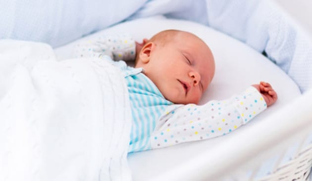 Baby sleeping in cot