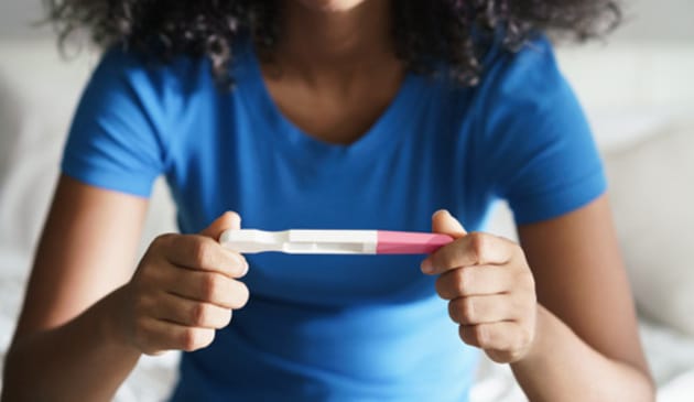 Woman looking at a pregnancy test