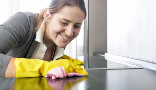Woman cleaning hob