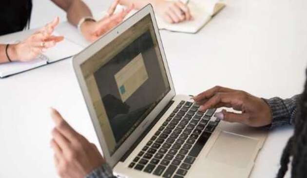 Hands using laptop