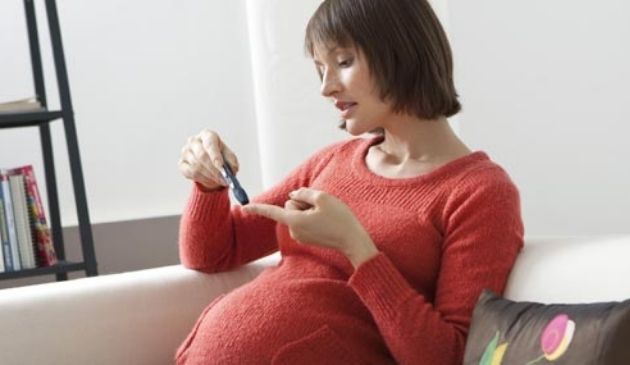 pregnant woman performing glucose test