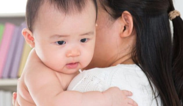 Baby being held by mother