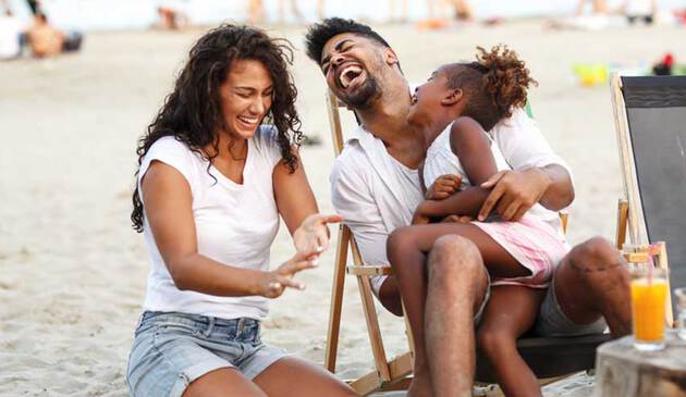 Family laughing on the beach