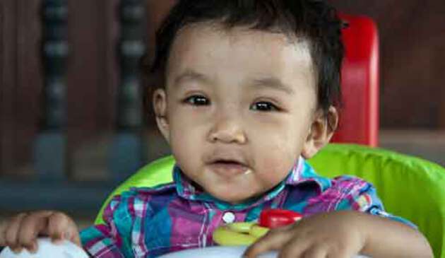 Eight month old baby in high chair