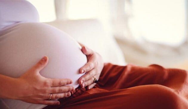 Pregnant woman sitting down