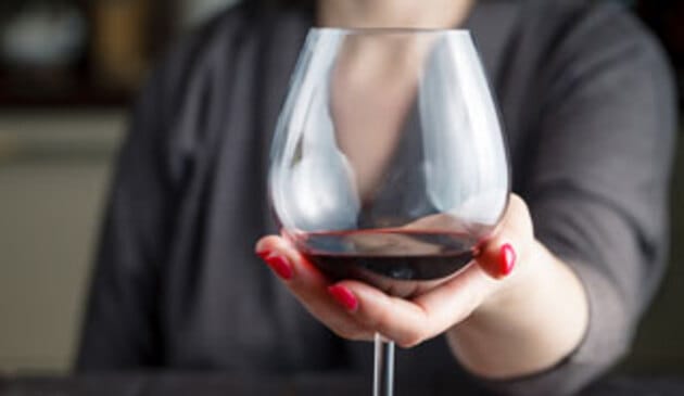 Woman holding glass of wine