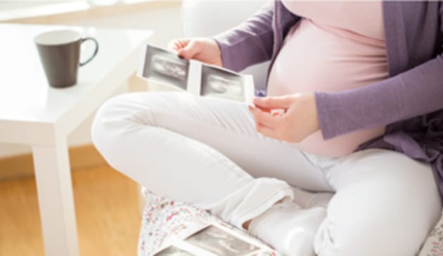 Pregnant woman looking at a baby scan